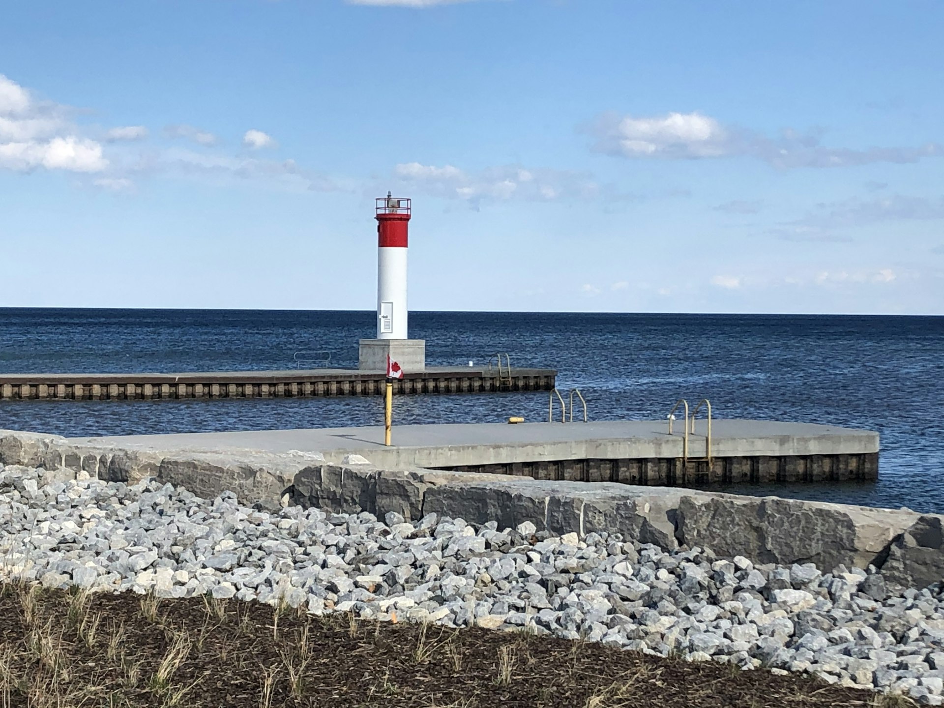 Red and white lighthouse on the pier at Oakville harbour, Lake Ontario