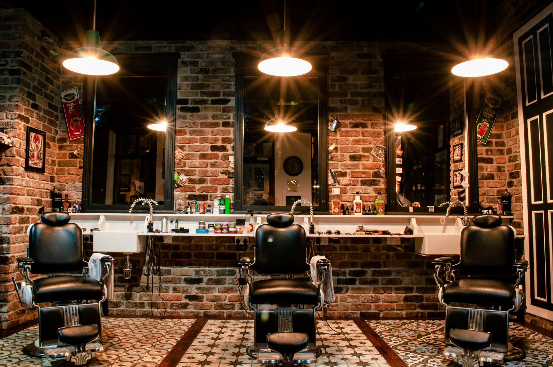 Empty barber shop with a leather barber chair and brick walls