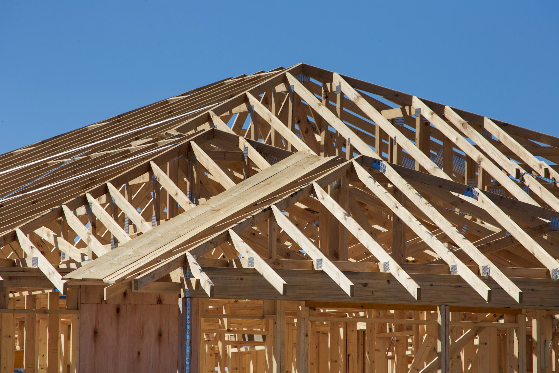 Wood roof trusses and framing of a house under construction