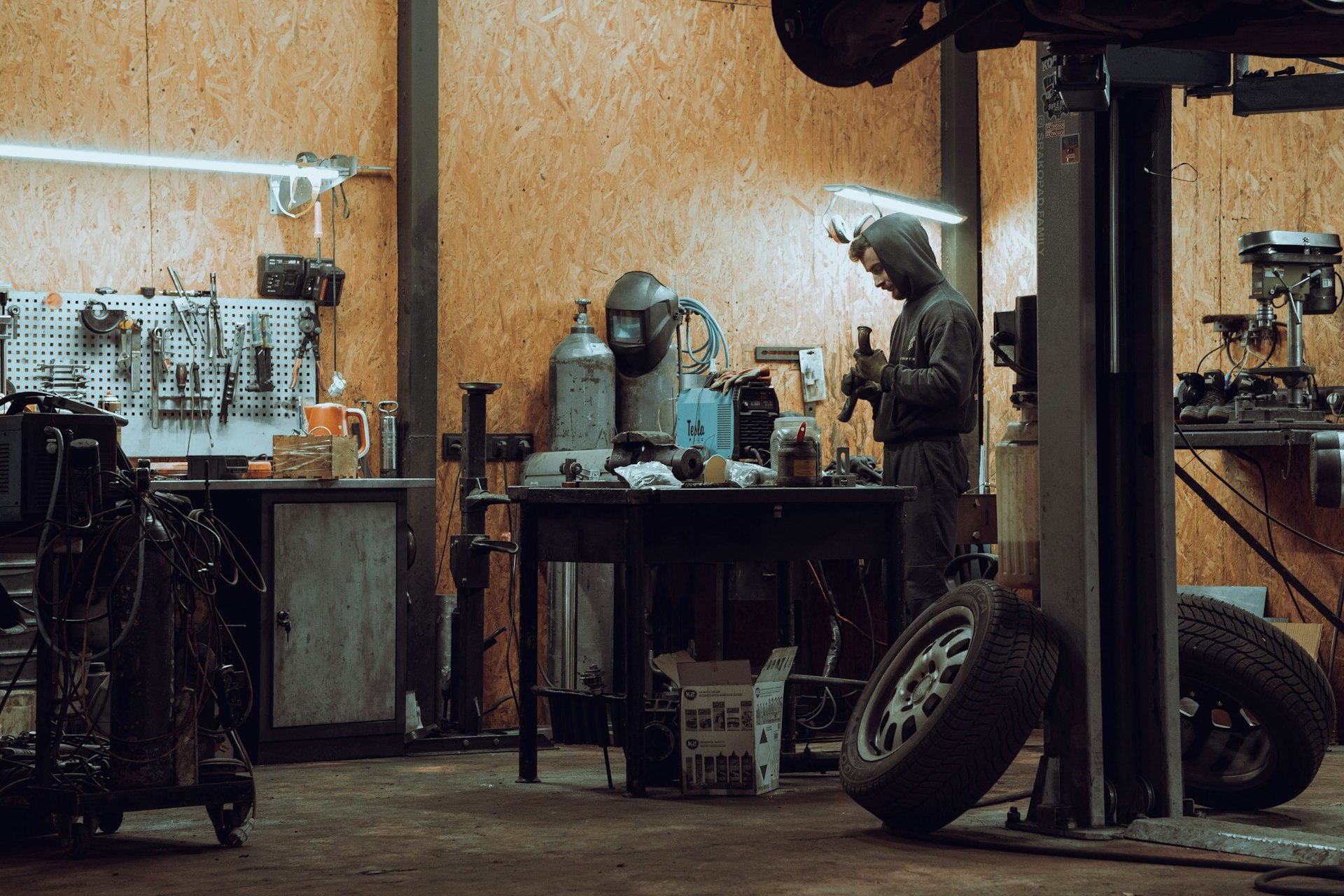 Mechanic working at a bench in a small auto repair garage