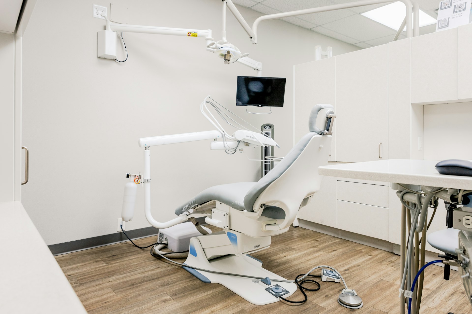 Modern dental treatment room with chair and equipment