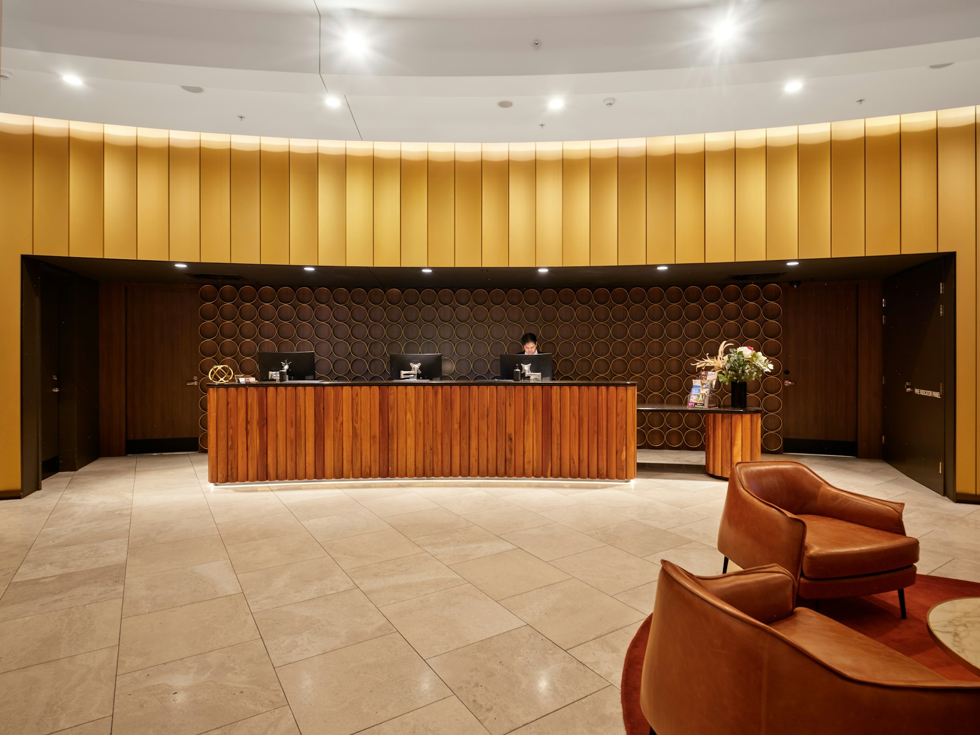 Hotel lobby with a wooden reception desk and lounge seating