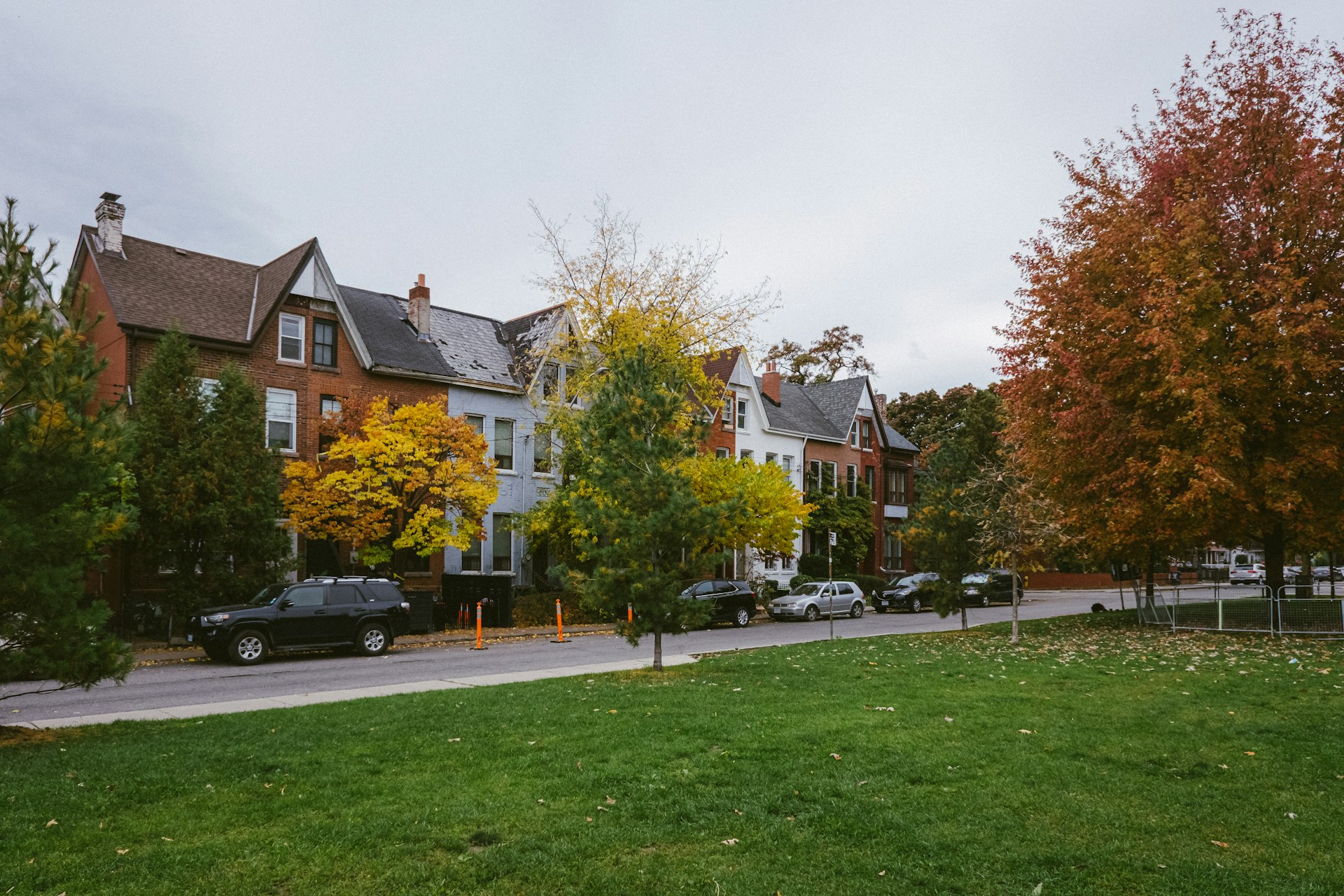 Row of brick houses on a Toronto street with autumn trees